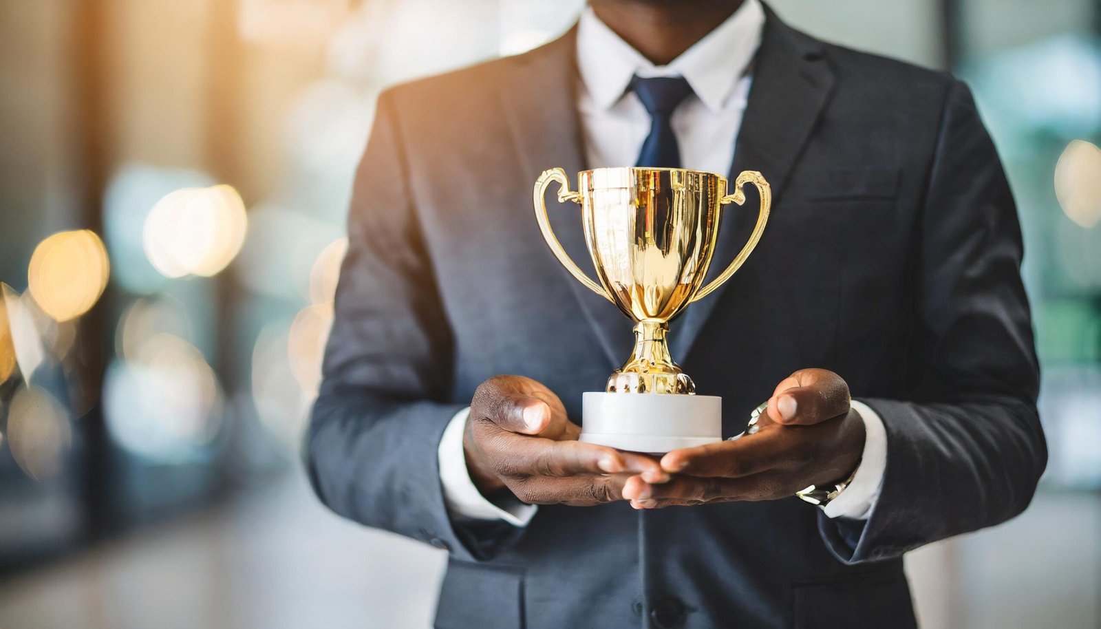businessmans-hand-holds-leadership-trophy-symbolizing-success-achievement